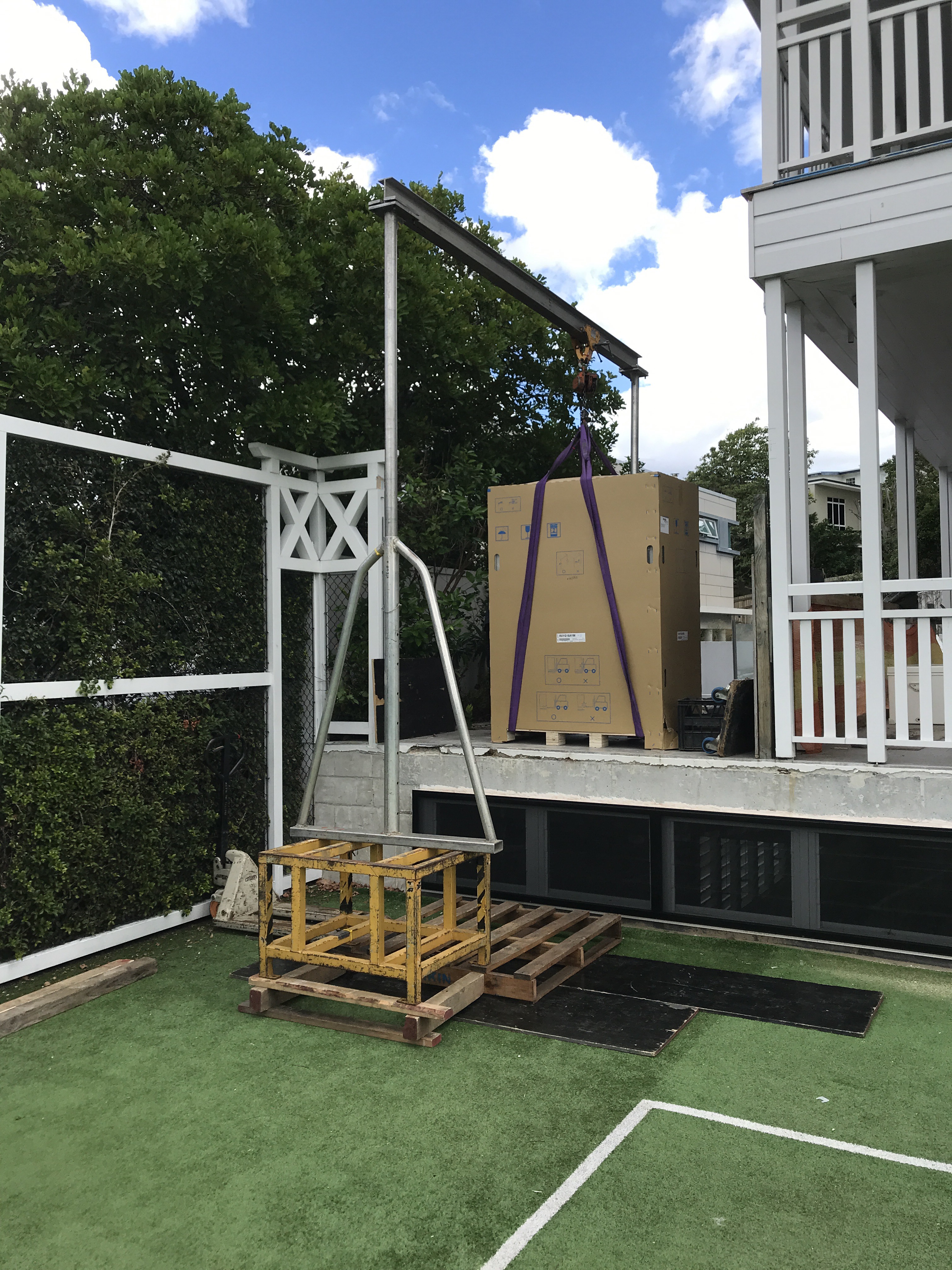 white goods being delivered to residential using manual forklift